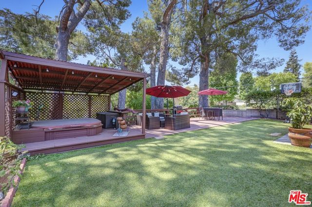 an outdoor sitting area with chairs and umbrella