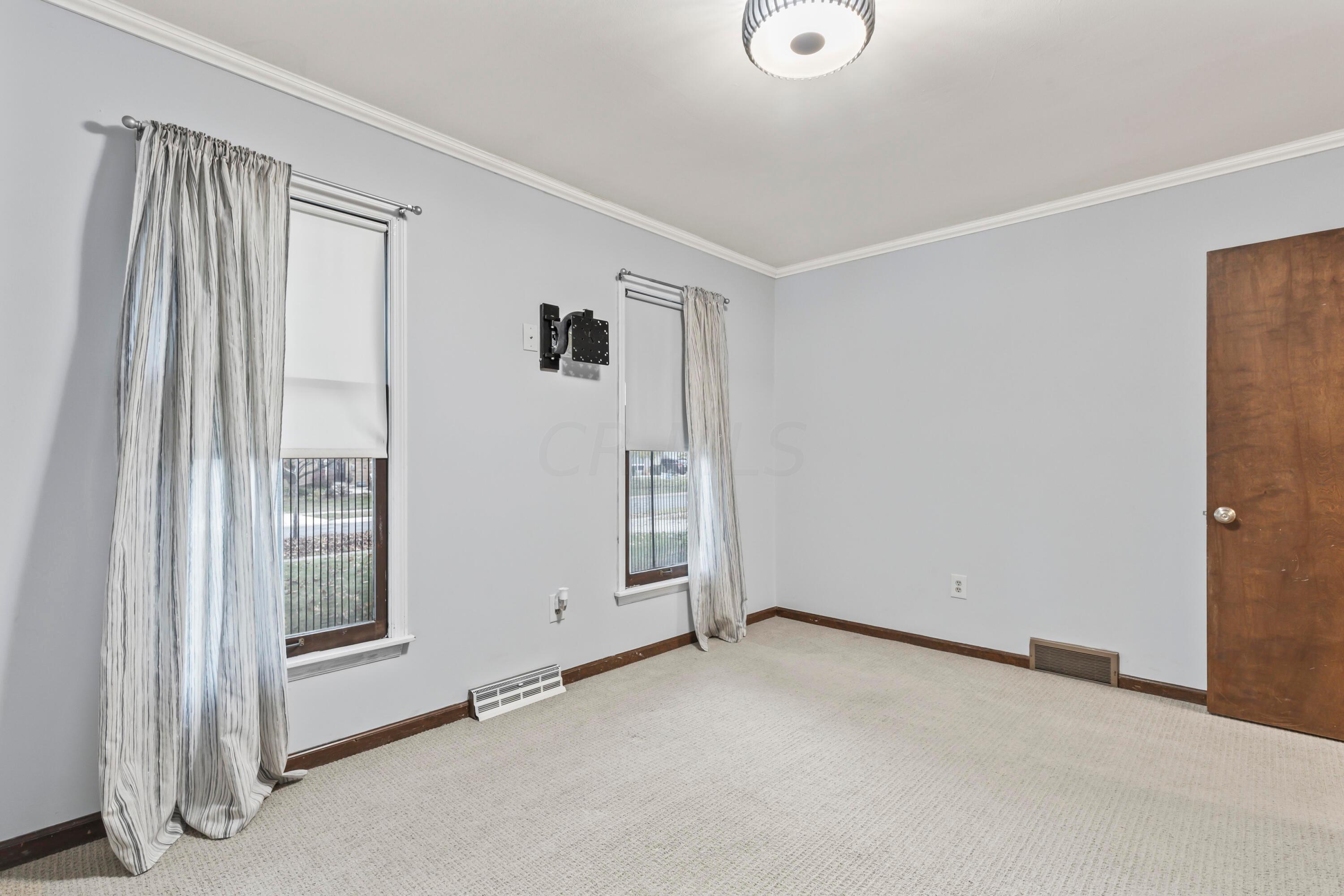 7020 Rieber Street Columbus, OH 43085 - Photo 33 of 40 • Berber carpet • Blue/grey painted walls • New ceiling light ~ 2017 • Drapes are negotiable • Closet with double sliding doors