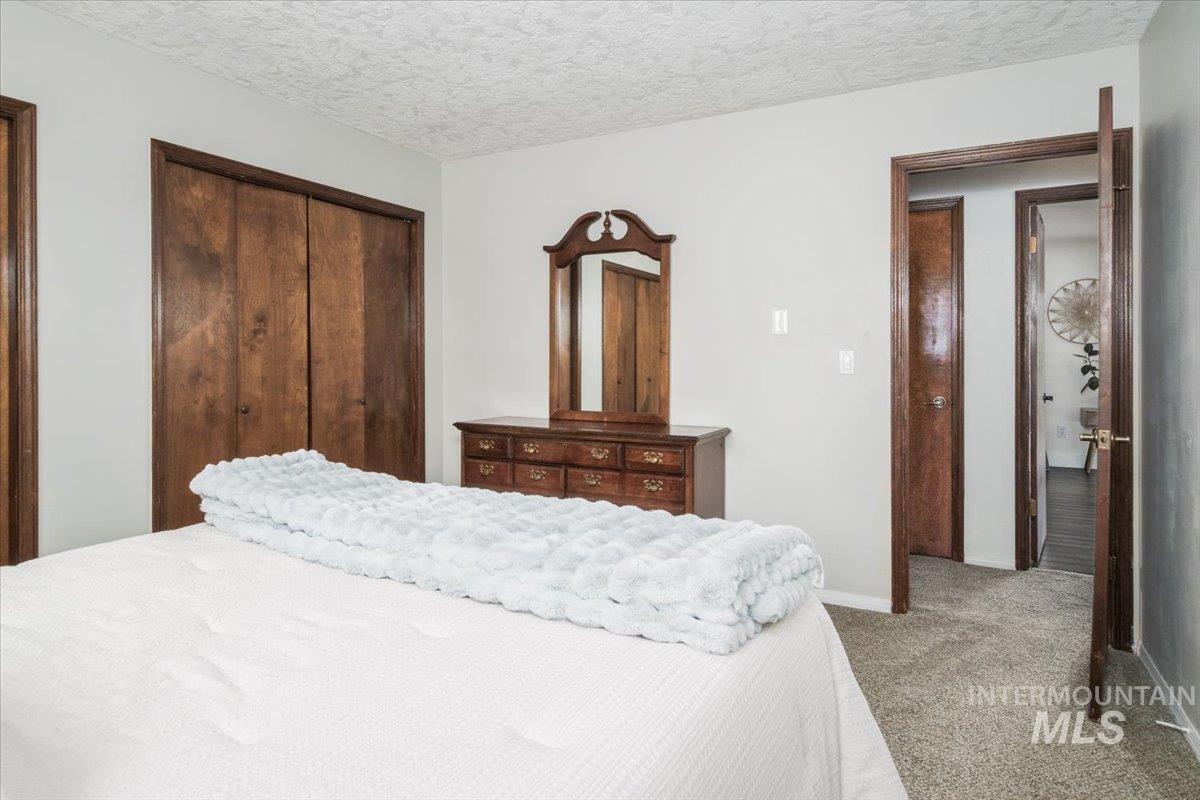 1401 Chokecherry Drive Pocatello, ID 83204 - Photo 31 of 46 Bedroom featuring light gray walls, textured ceiling, and gray carpet flooring
