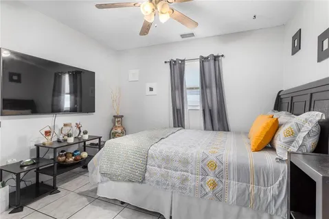 a large bed in a bedroom next to a window