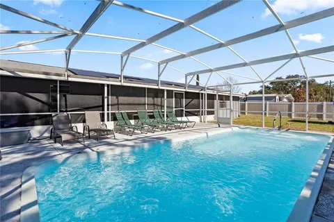 a view of a backyard with swimming pool
