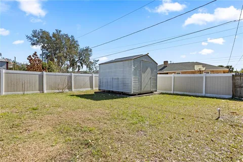 a view of house with backyard and tree
