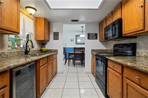 a kitchen with stainless steel appliances granite countertop a sink and a counter top space