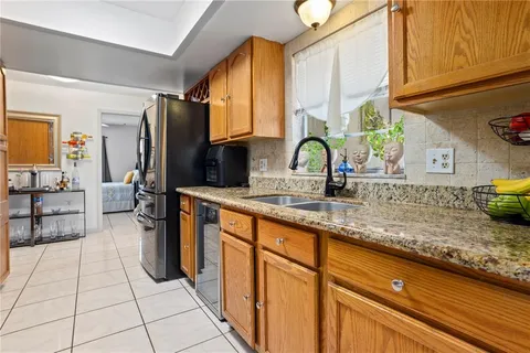 a kitchen with stainless steel appliances granite countertop a stove microwave and cabinets