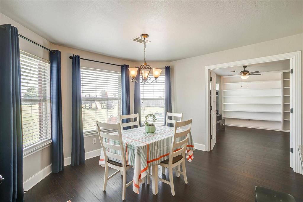 101 Springfield Lane Red Oak, TX 75165 - Photo 15 of 38 a view of a dining room with furniture window and wooden floor