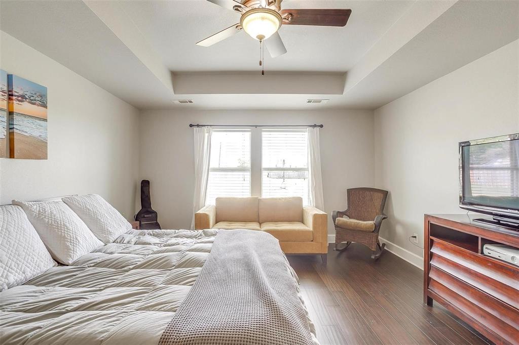 101 Springfield Lane Red Oak, TX 75165 - Photo 20 of 38 a bedroom with a bed and wooden floor