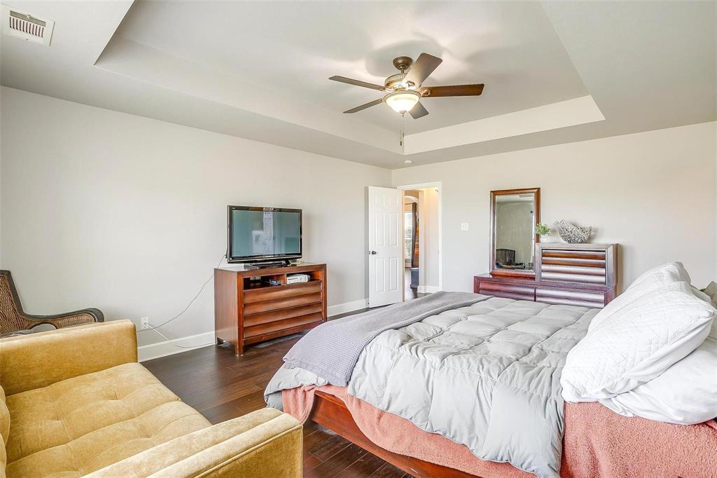 101 Springfield Lane Red Oak, TX 75165 - Photo 21 of 38 a bedroom with a bed and a flat screen tv