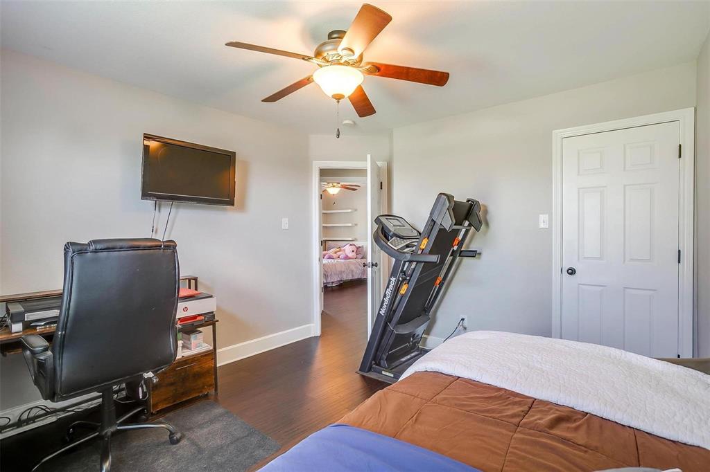 101 Springfield Lane Red Oak, TX 75165 - Photo 26 of 38 a bedroom with furniture wooden floor and a ceiling fan