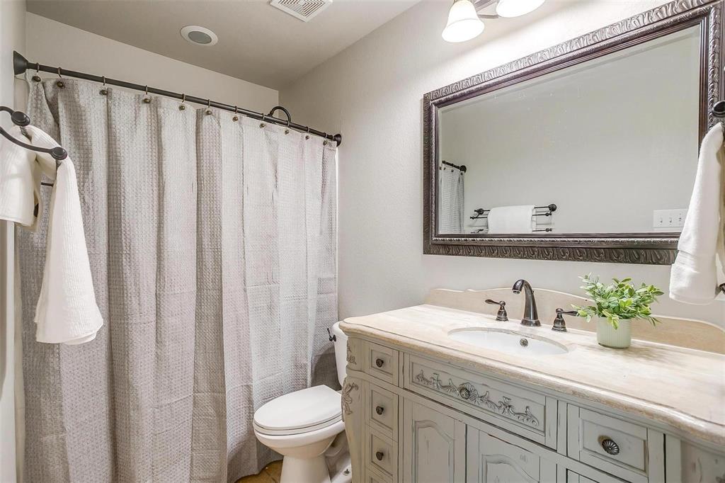 101 Springfield Lane Red Oak, TX 75165 - Photo 27 of 38 a bathroom with a granite countertop sink a toilet and a mirror