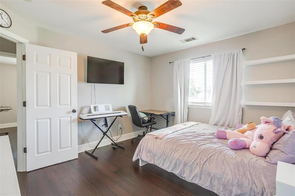 101 Springfield Lane Red Oak, TX 75165 - Photo 31 of 38 a bedroom with a bed and a flat screen tv