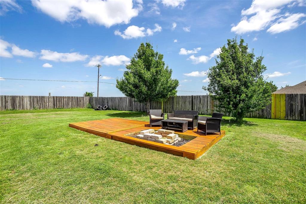 101 Springfield Lane Red Oak, TX 75165 - Photo 37 of 38 a view of a backyard with couches plants and large tree