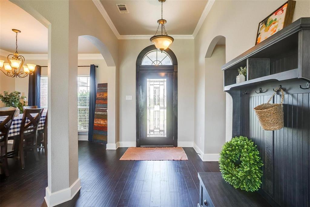 101 Springfield Lane Red Oak, TX 75165 - Photo 5 of 38 a view of a hallway with wooden floor windows and a kitchen