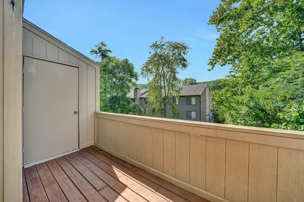 a view of balcony with wooden floor