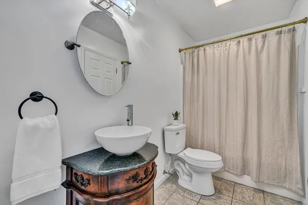 a room with a white walls and a mirror