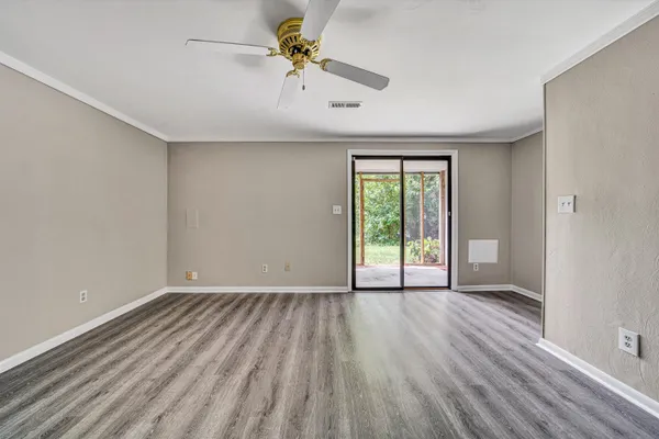a view of a room with wooden floor