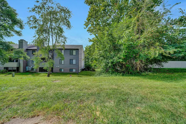 a view of a house with backyard and garden