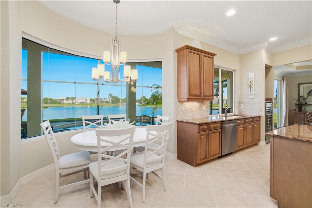 1879 Ivory Cane Point Naples, FL 34119 - Photo 12 of 49 a kitchen with kitchen island granite countertop a table and chairs