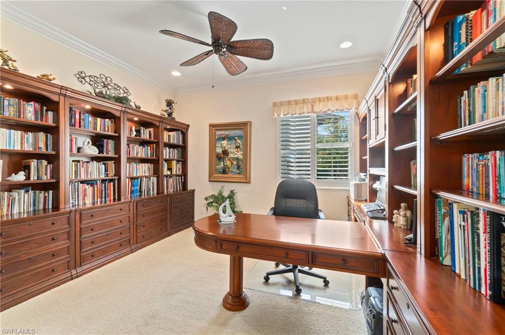 1879 Ivory Cane Point Naples, FL 34119 - Photo 16 of 49 a view of a workspace with furniture and a bookshelf