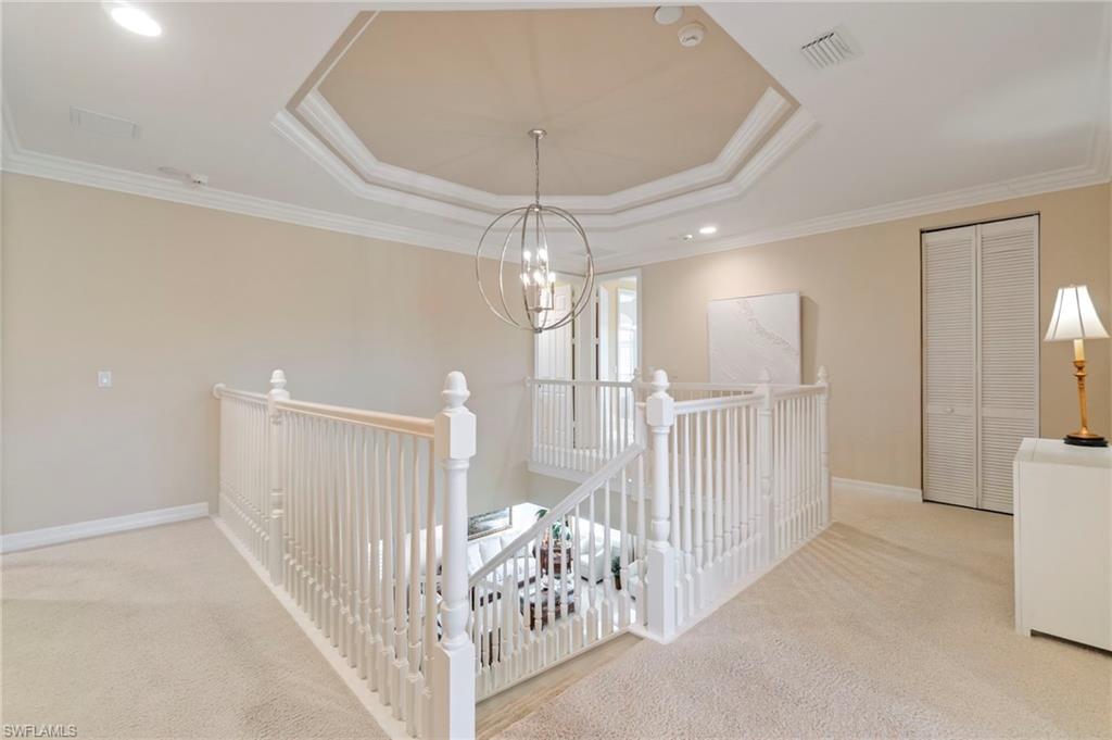 1879 Ivory Cane Point Naples, FL 34119 - Photo 20 of 49 a view of a hallway with a chandelier