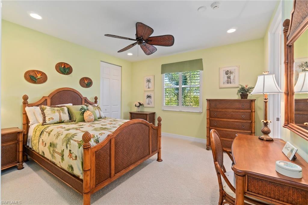1879 Ivory Cane Point Naples, FL 34119 - Photo 29 of 49 a bedroom with a bed and a chandelier