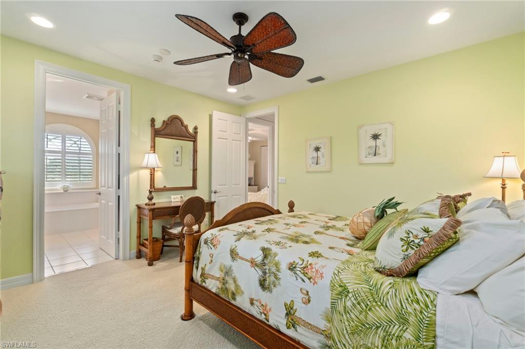 1879 Ivory Cane Point Naples, FL 34119 - Photo 30 of 49 a bedroom with a bed and a large mirror