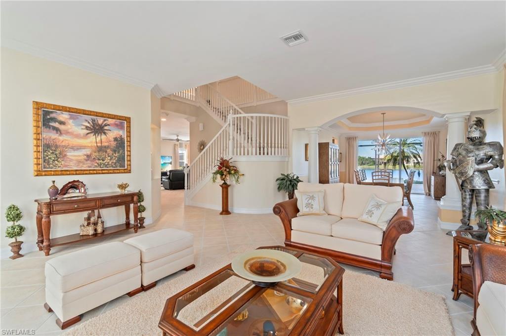 1879 Ivory Cane Point Naples, FL 34119 - Photo 3 of 49 a living room with furniture a rug and white walls