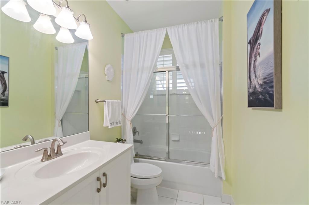 1879 Ivory Cane Point Naples, FL 34119 - Photo 34 of 49 a bathroom with a sink a toilet and a large mirror