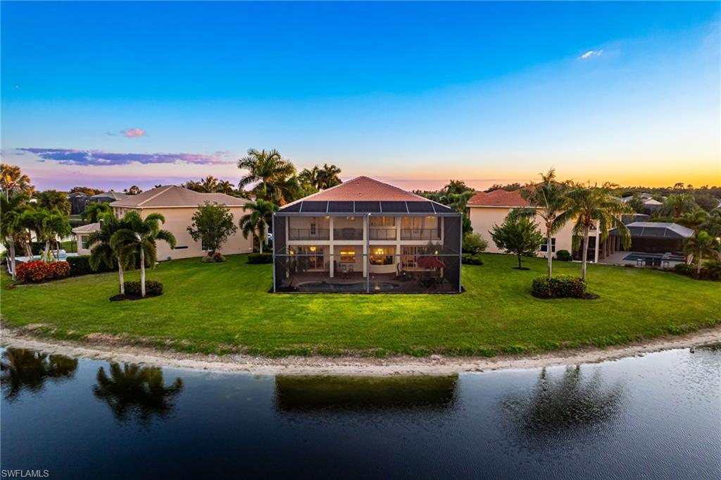 1879 Ivory Cane Point Naples, FL 34119 - Photo 47 of 49 a view of a garden with a house in the background
