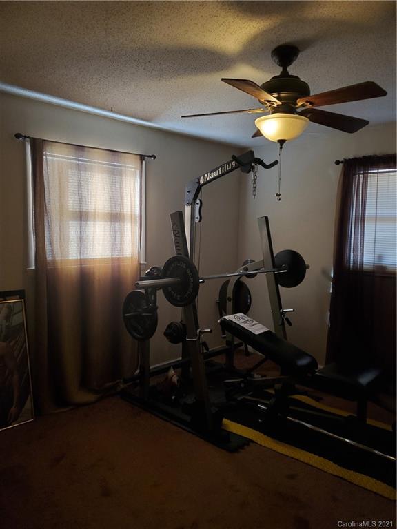 6365 Bringle Ferry Road Salisbury, NC 28146 - Photo 12 of 16 a room with gym equipment and windows