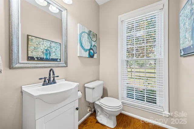 a bathroom with a toilet a sink and a window