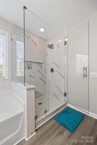 a bathroom with a tub and shower
