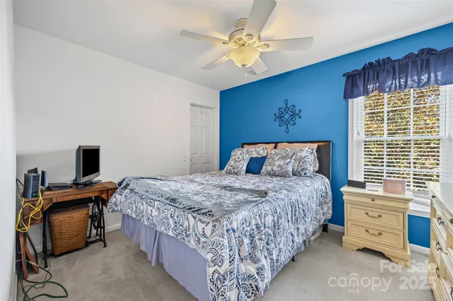 a bedroom with a bed and a television