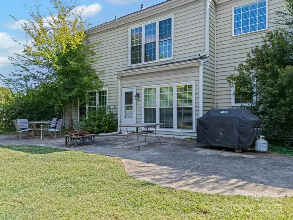 a view of a house with backyard and sitting area
