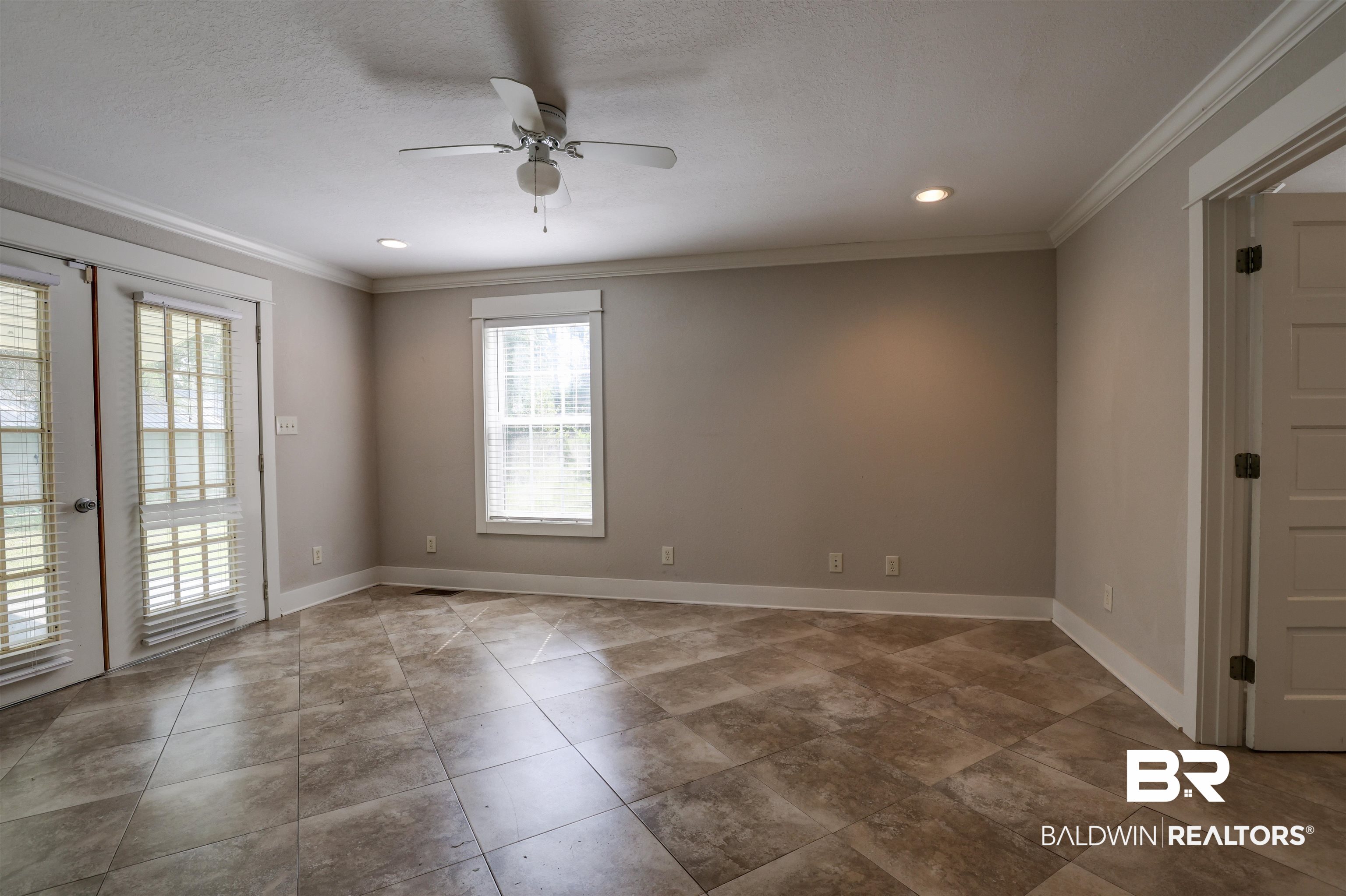 2079 Alabama Street Loxley, AL 36551 - Photo 16 of 42 Tiled empty room featuring a textured ceiling, ceiling fan, french doors, and crown molding