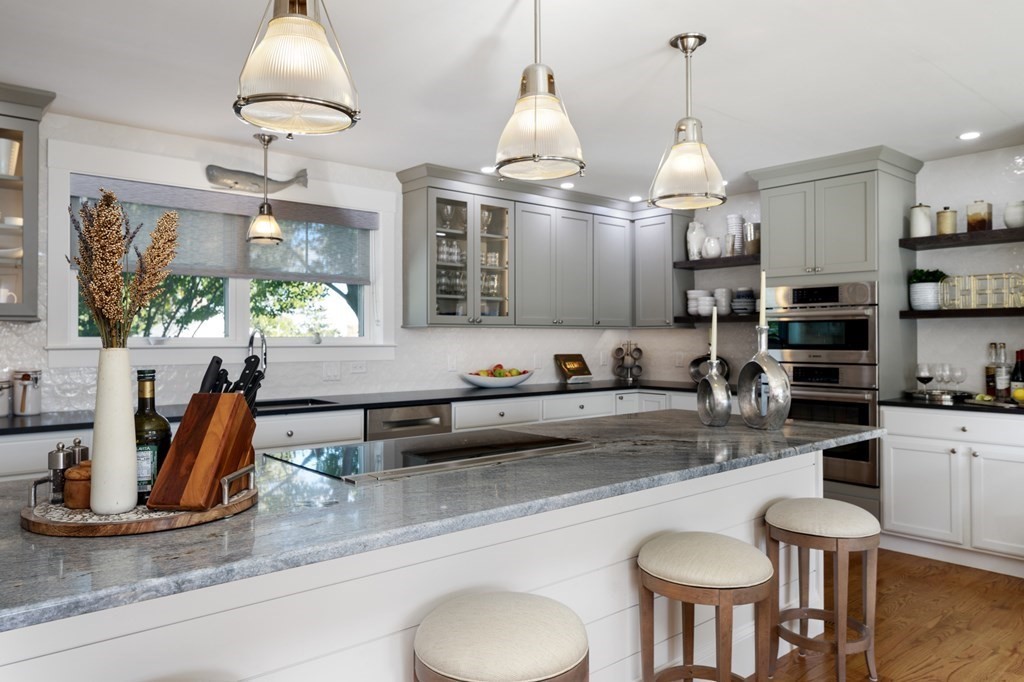 18 Clifton Avenue Hull, MA 02045 - Photo 12 of 39 a kitchen with stainless steel appliances granite countertop a sink a stove and a wooden floors