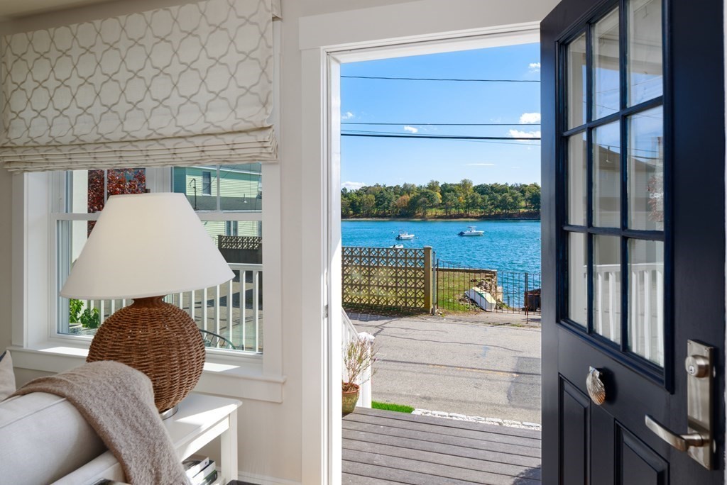 18 Clifton Avenue Hull, MA 02045 - Photo 4 of 39 view of living room with furniture and a floor to ceiling window