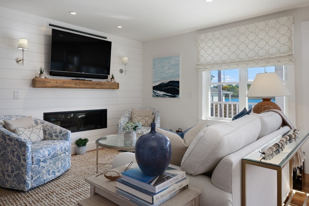 18 Clifton Avenue Hull, MA 02045 - Photo 5 of 39 a living room with furniture a flat screen tv and a fireplace