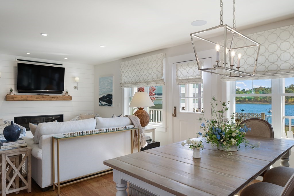 18 Clifton Avenue Hull, MA 02045 - Photo 7 of 39 a kitchen with stainless steel appliances granite countertop a dining table chairs and chandelier
