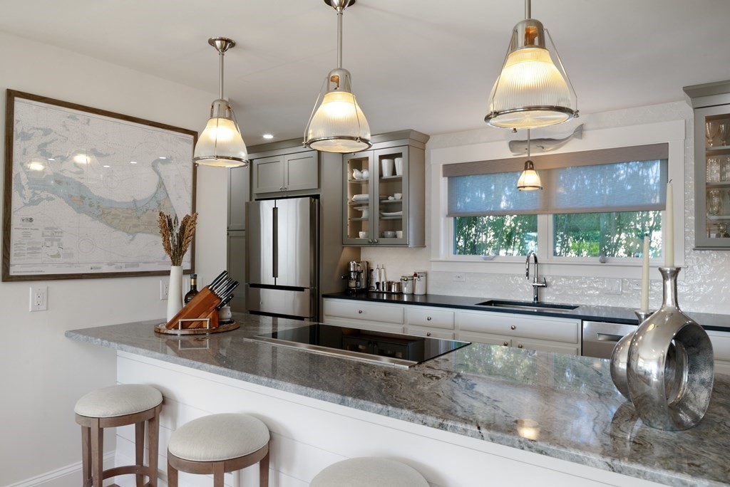 18 Clifton Avenue Hull, MA 02045 - Photo 10 of 39 a kitchen with a sink a counter top space and a chandelier