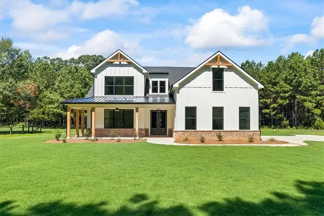a front view of house with yard and green space