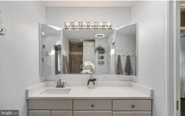 a bathroom with a sink vanity and a mirror
