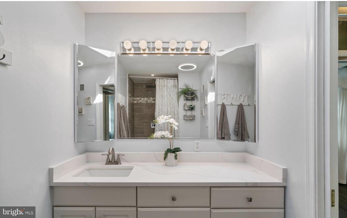 11611 Vale Road Oakton, VA 22124 - Photo 11 of 24 Sleek modern bathroom with elegant mirrors.