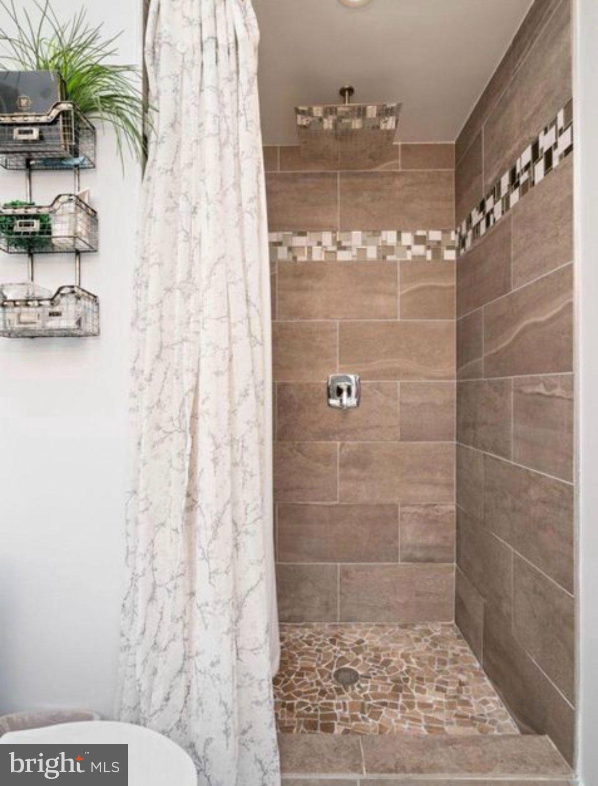 11611 Vale Road Oakton, VA 22124 - Photo 12 of 24 Elegant shower with modern tiles.
