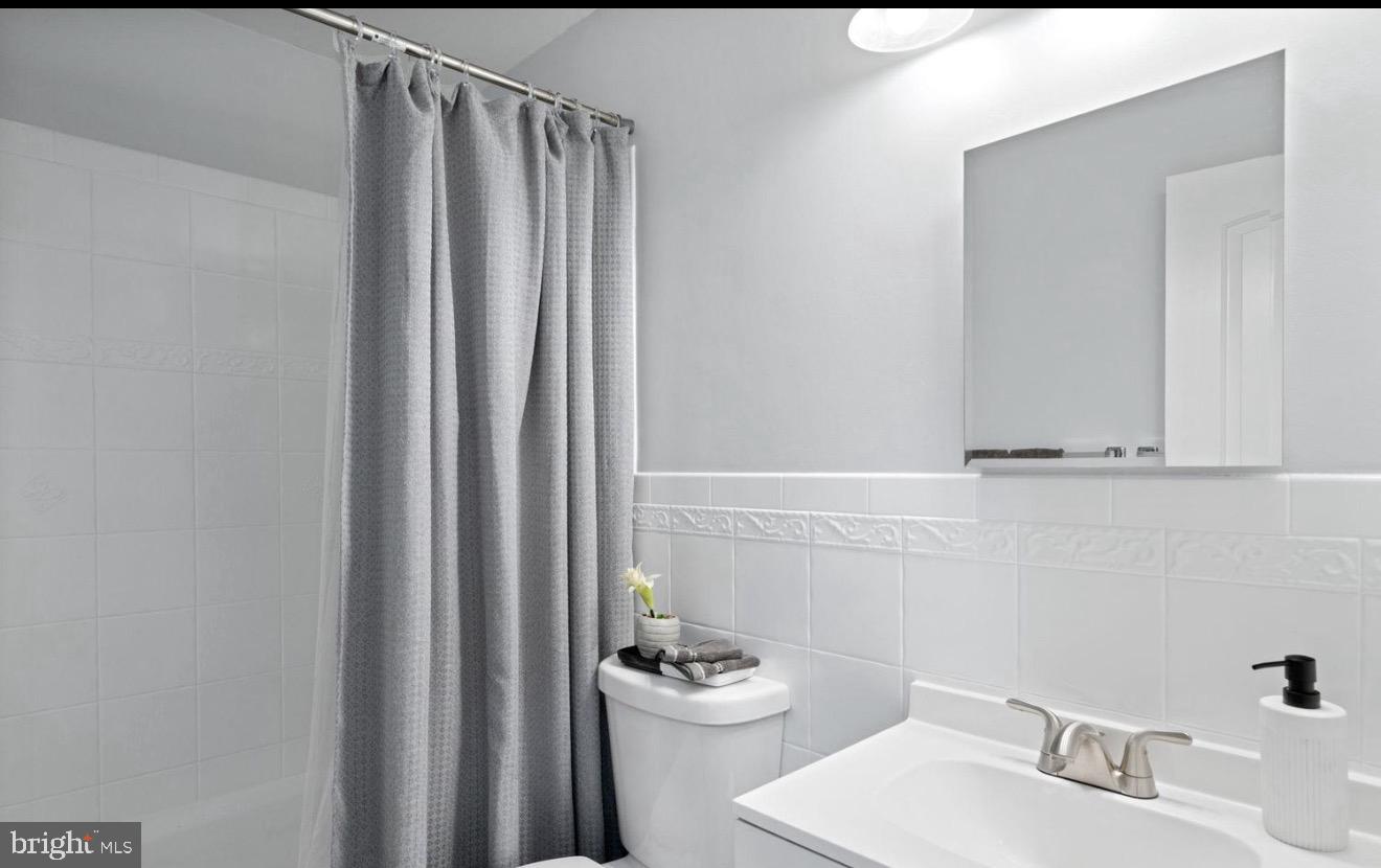 11611 Vale Road Oakton, VA 22124 - Photo 17 of 24 Sleek and modern bathroom retreat.