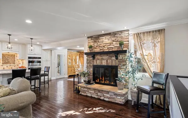a living room with furniture fireplace and dining table