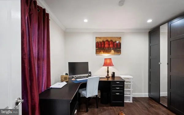 a view of a workspace with furniture and wooden floor