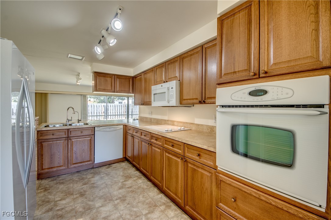 3728 Deleon Street Fort Myers, FL 33901 - Photo 14 of 50 a kitchen with granite countertop a stove top oven microwave and cabinets