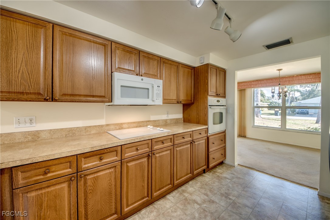 3728 Deleon Street Fort Myers, FL 33901 - Photo 16 of 50 a kitchen with stainless steel appliances granite countertop wooden cabinets a sink and dishwasher