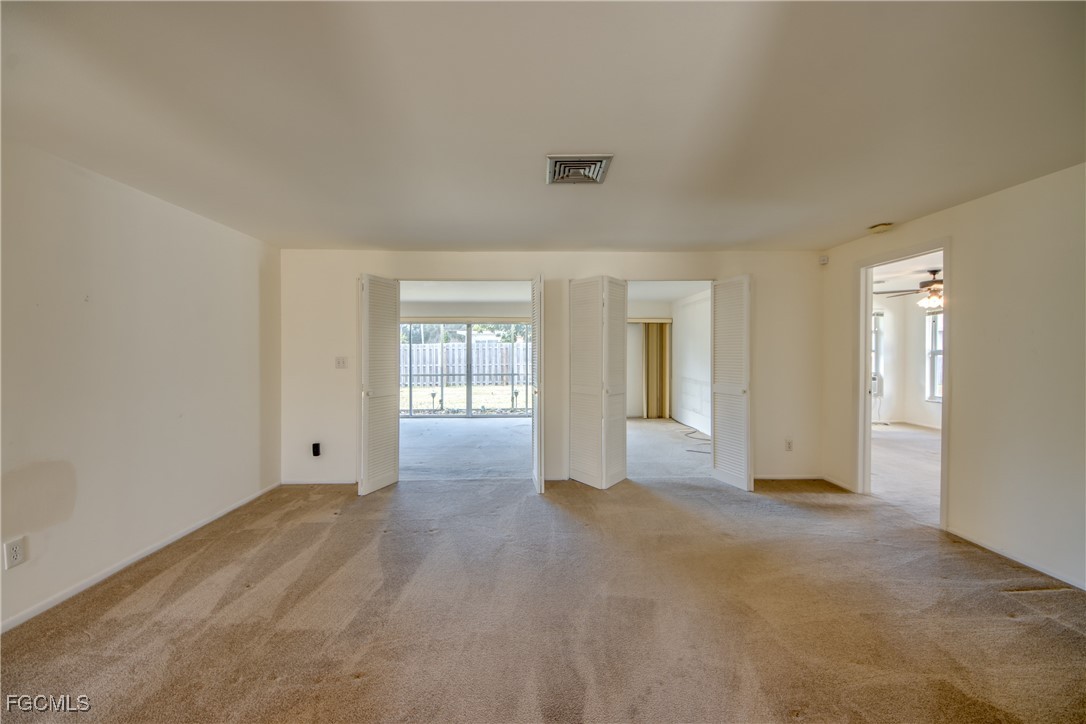 3728 Deleon Street Fort Myers, FL 33901 - Photo 27 of 50 a view of an empty room with window and wooden floor