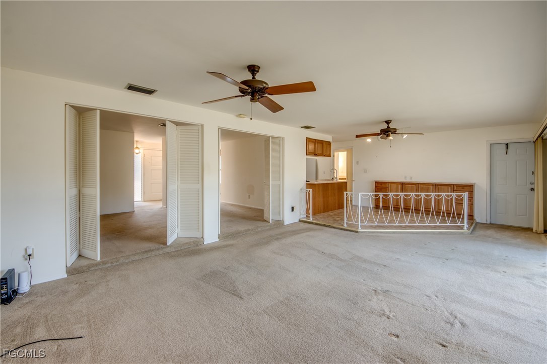 3728 Deleon Street Fort Myers, FL 33901 - Photo 28 of 50 a view of a livingroom with a ceiling fan and hallway